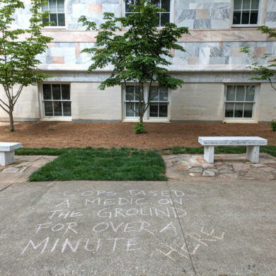 Image of graffiti near Emory Quadrangle saying, cops tased a medic on the ground for over a minute here.